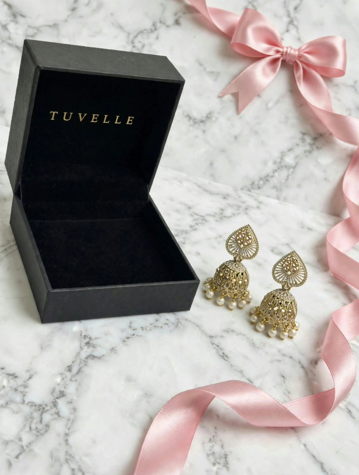 Close-up of Mehr jhumka earrings showing teardrop tops and pearl-look bead fringes