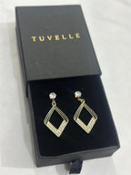 Aria geometric sparkle earrings beside a TUVELLE box on a marble background