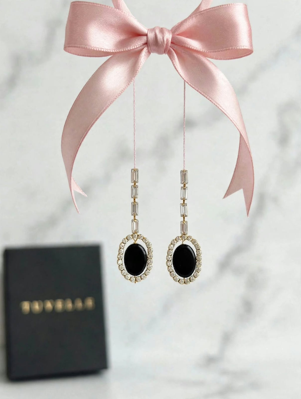 Noor black oval halo earrings displayed in a TUVELLE box
